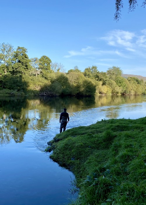 The amazing beauty of the Tay Valley is perfectly displayed here at the neck of the Channel Pool looking downstream to the gravel riverbank in the far distance which is where the River Tummel enters the Tay. This salmon spin fisher had come all the way from Italy to fish the Tay for salmon.
