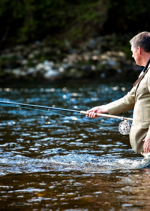 Here's a shot of myself in the Meetings Pool of the River Tay near Pitlochry with my lucky Tweed jacket on and Sharpes of Aberdeen landing net over my shoulder. Professional Scottish photographer Louise Bellin took this fine shot moments before a salmon rattled my fly!