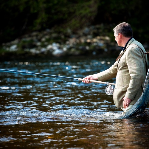 Here's a shot of myself in the Meetings Pool of the River Tay near Pitlochry with my lucky Tweed jacket on and Sharpes of Aberdeen landing net over my shoulder. Professional Scottish photographer Louise Bellin took this fine shot moments before a salmon rattled my fly!