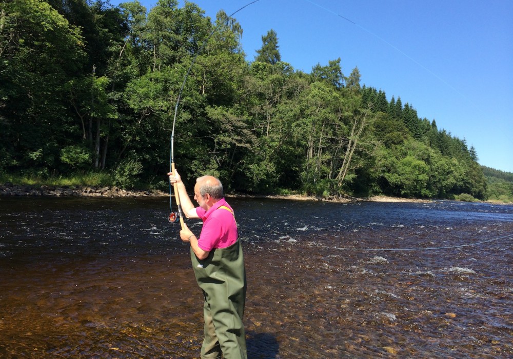 This pink shirted salmon angler is pictured here at the 'Joiner's Yard' Pool of the River Tummel near Ballinluig in Perthshire. He's learning the traditional Single Spey cast with this right hand. As he was doing so that day a salmon actually took the piece of red wool he was practising with!