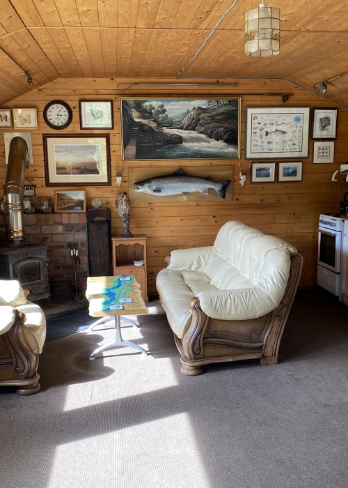 This is the well appointed interior of the Dalmarnock Beat fishing hut on the River Tay near Dunkeld. You'll see the wood burning stove over in the corner which is worth its weight in gold in the cold weather of early Spring.